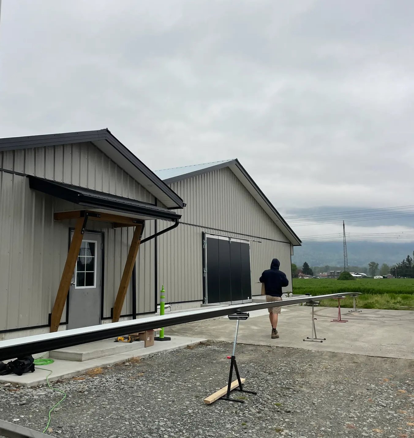 EDAPT Portable Solutions crew working on seamless gutter installation at a Fraser Valley job site